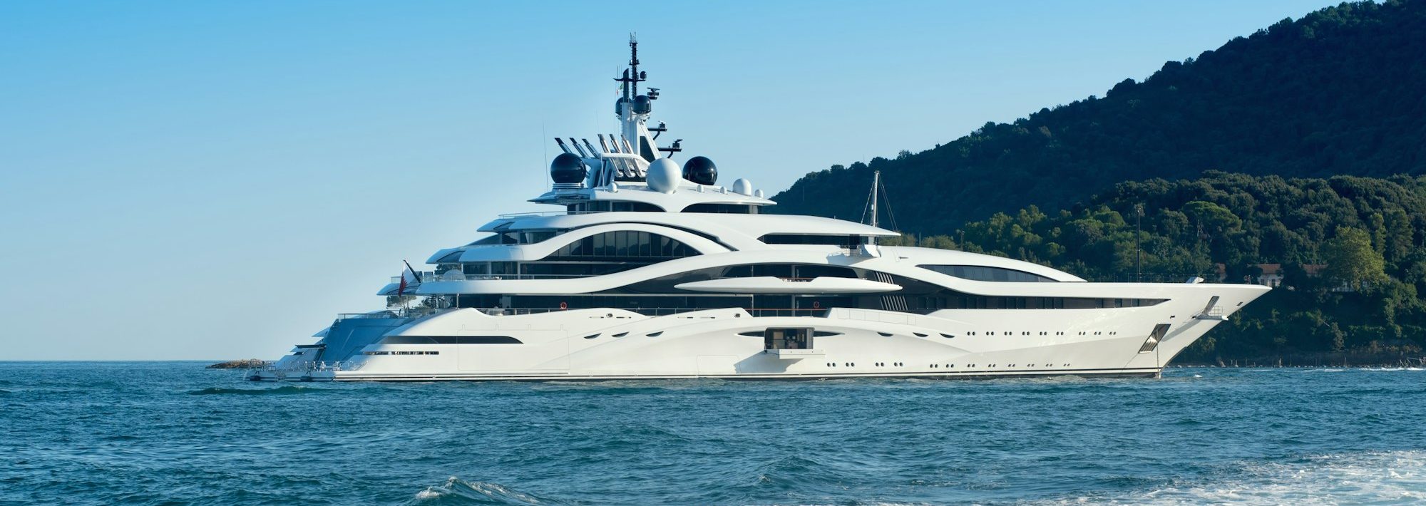 Huge luxury yacht cruising offshore